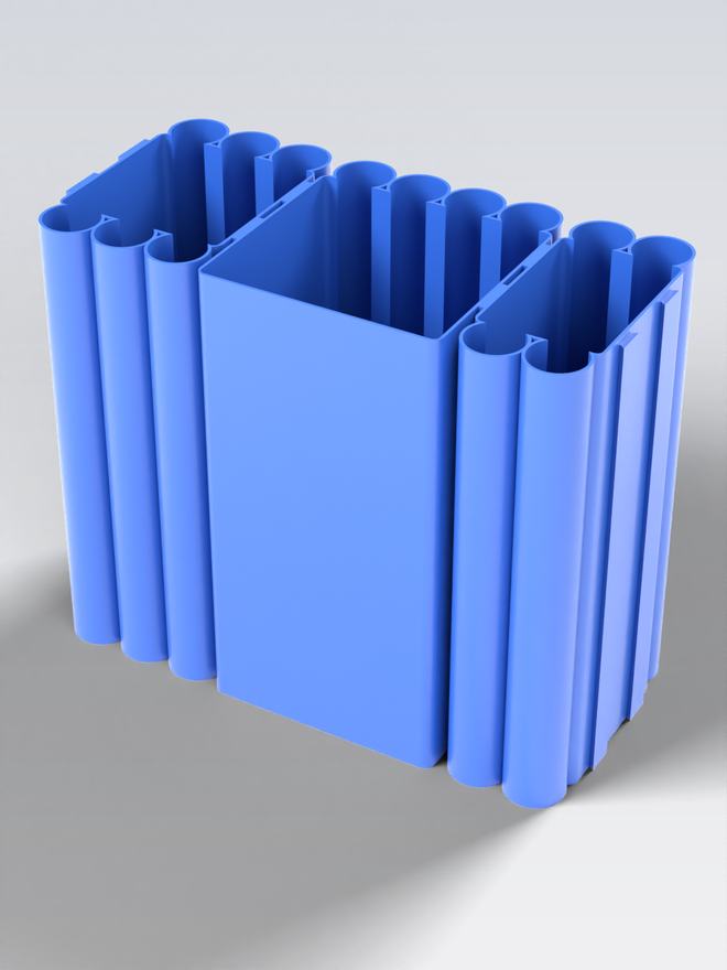 The three blue modules joined together, seen from above, with grip channels along the walls.